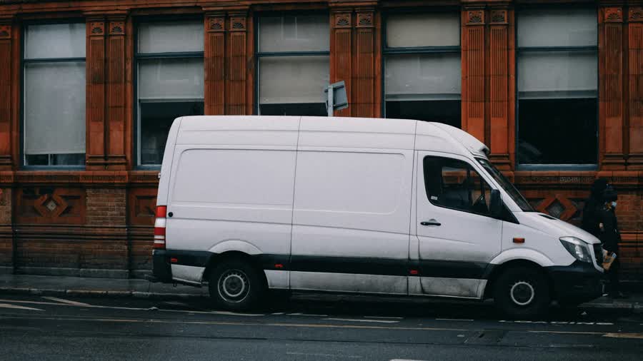 White Brightwater service van parked on a city street